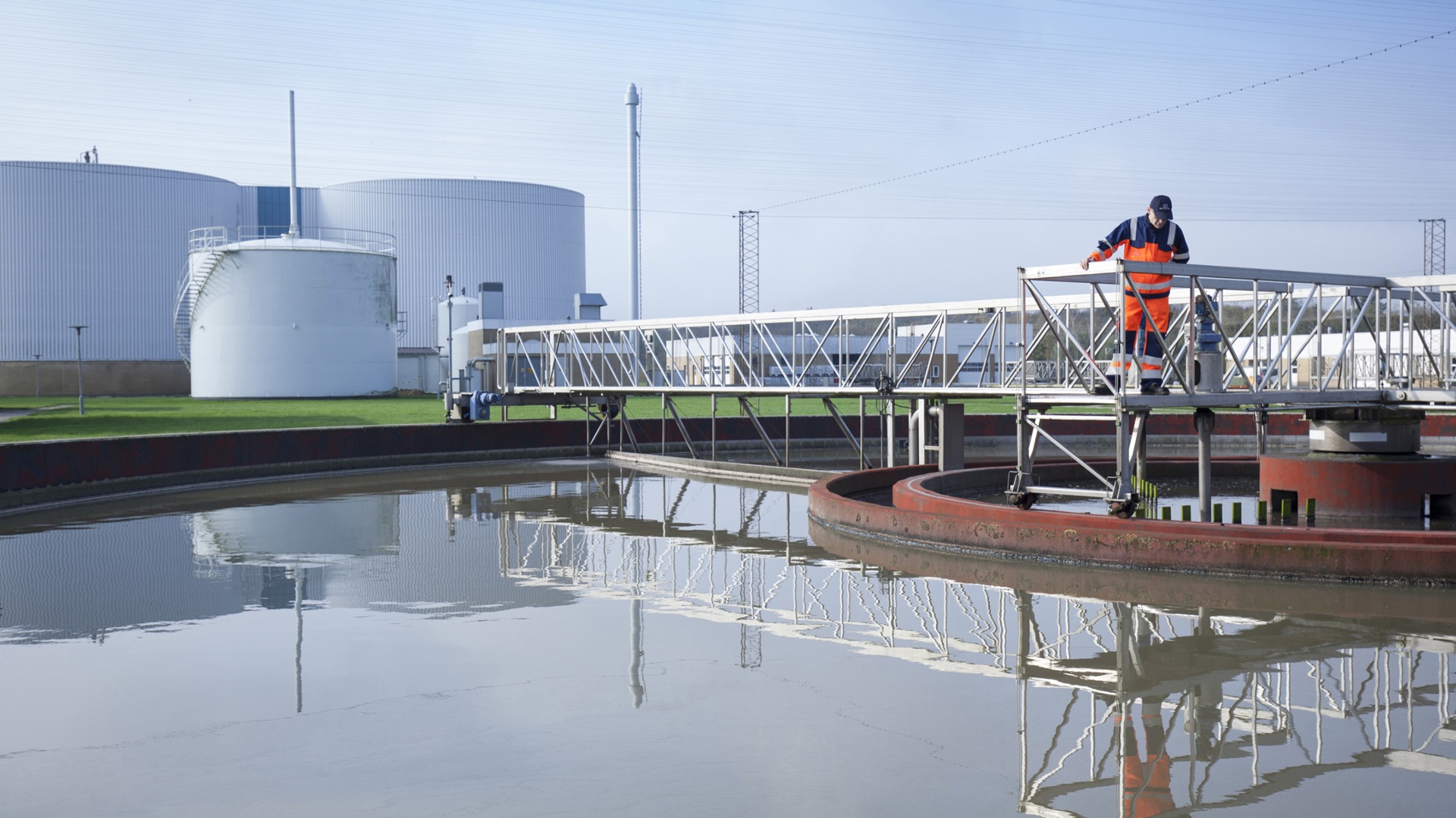 Wastewater plant, man looking into the water